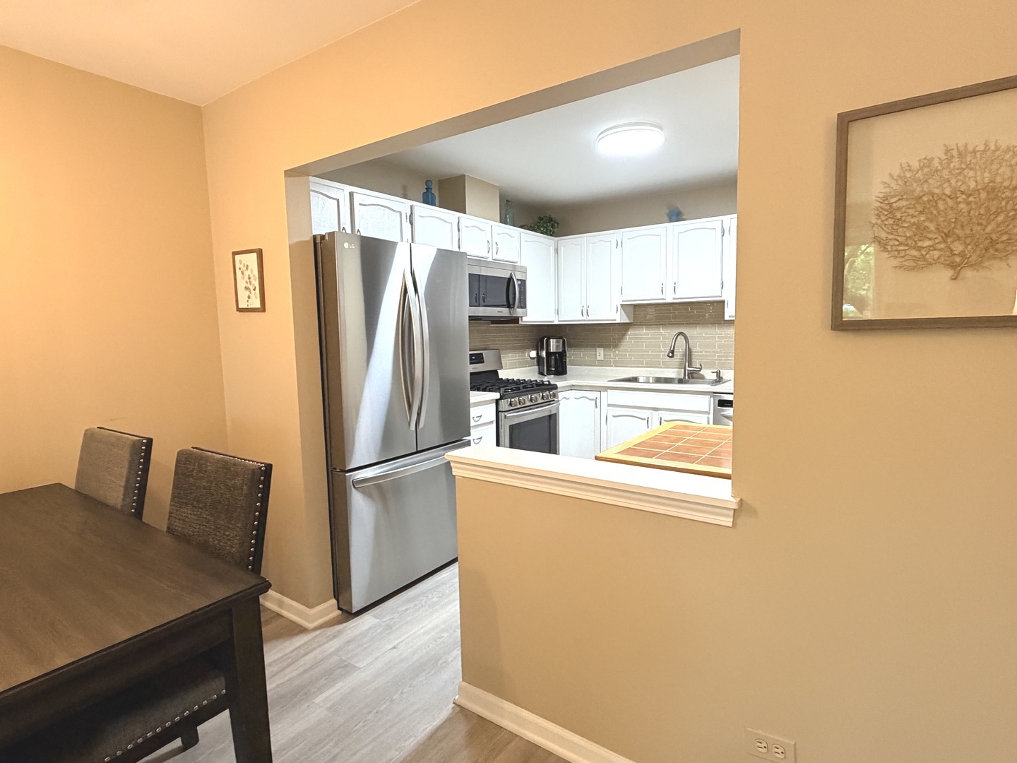 300 East Dundee Road, Unit 102A Buffalo Grove, IL 60089 - Photo 7 of 27 a kitchen with stainless steel appliances a refrigerator and a stove top oven