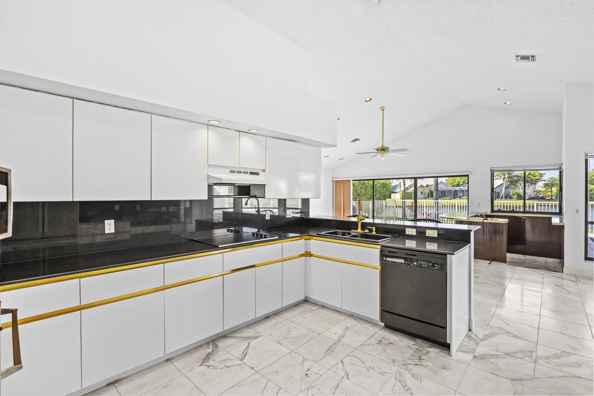 10747 Stonebridge Boulevard Boca Raton, FL 33498 - Photo 17 of 75 a kitchen with stainless steel appliances granite countertop a sink and white cabinets