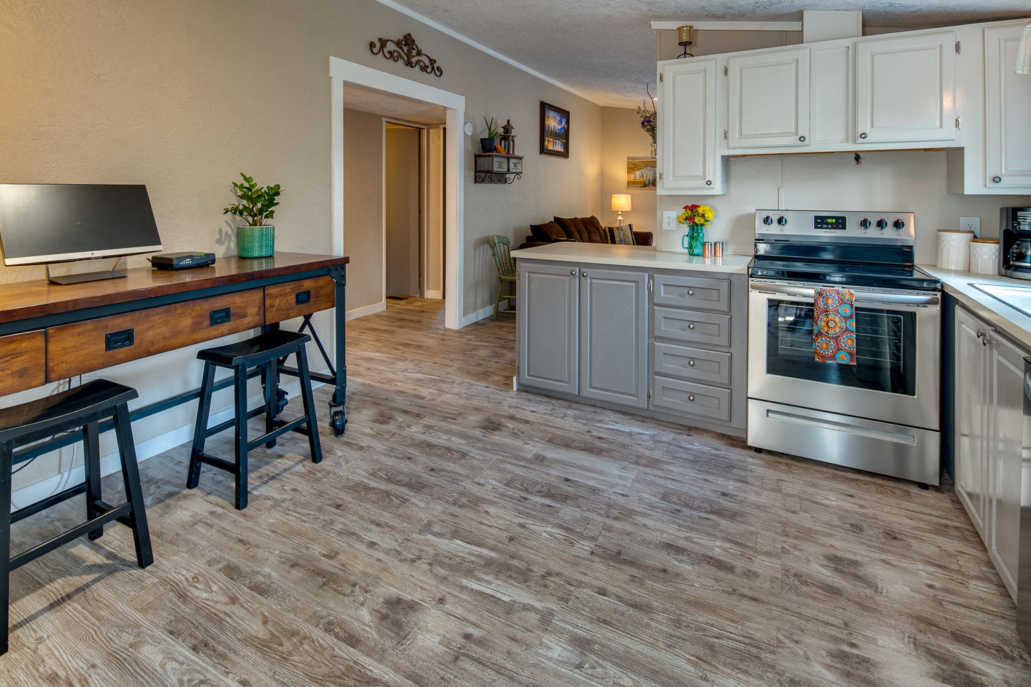 19197 Kiowa Road Bend, OR 97702 - Photo 20 of 32 a kitchen with stainless steel appliances a stove a sink white cabinets and a refrigerator