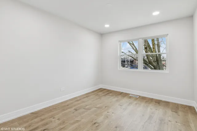 an empty room with a painting on the wall