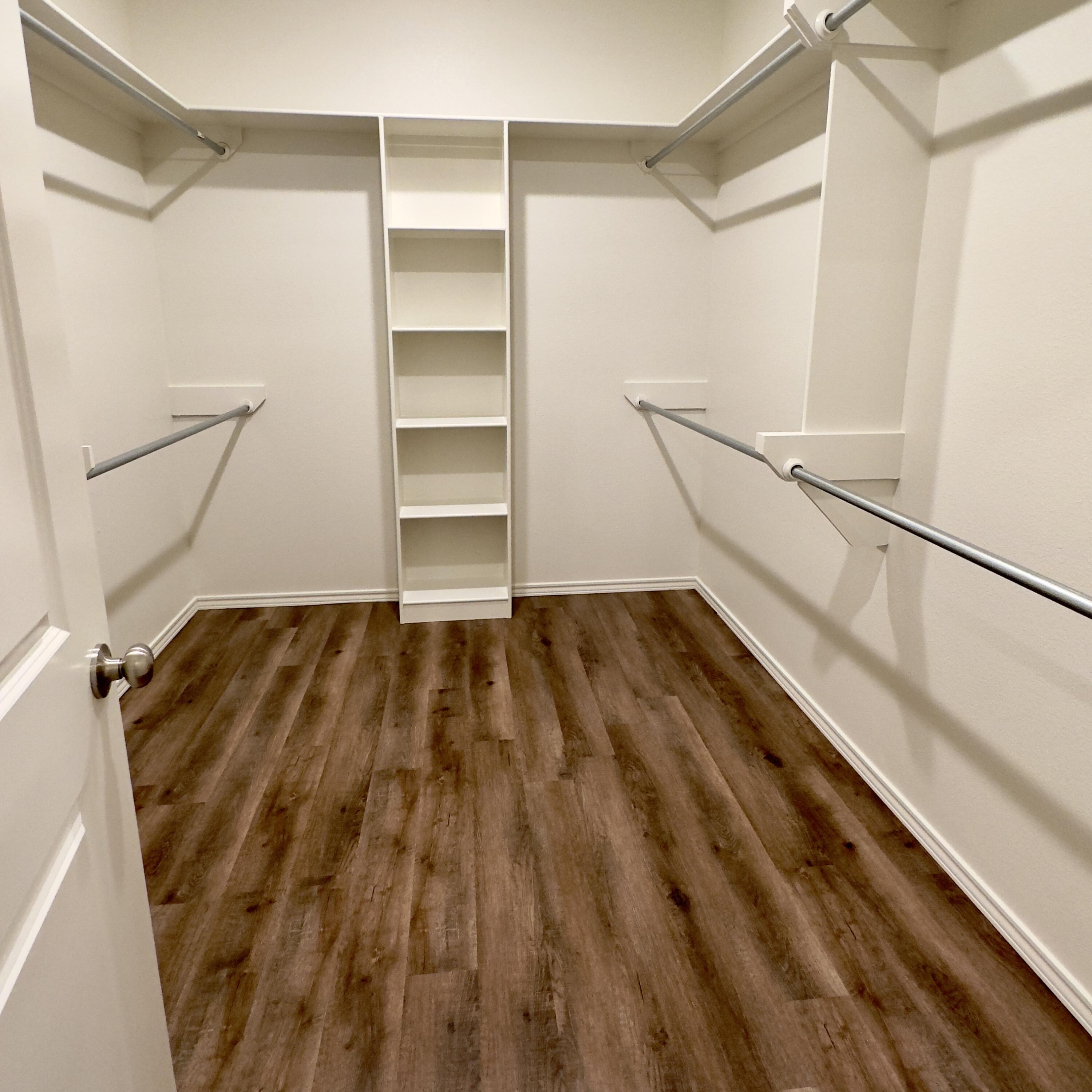 1225 Preston Trail, Unit A Wolfforth, TX 79382 - Photo 14 of 16 a view of walk in closet with empty racks