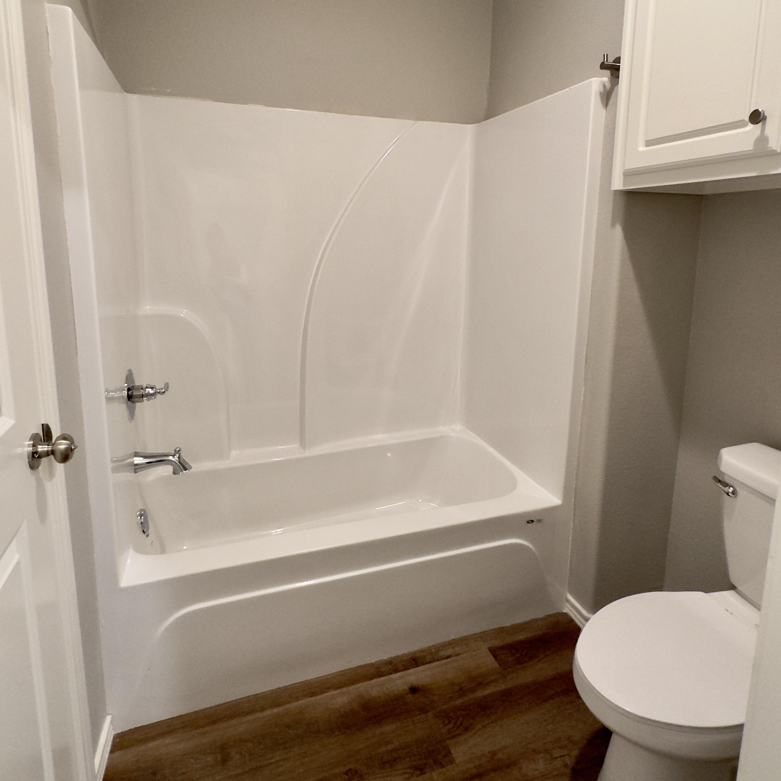 1225 Preston Trail, Unit A Wolfforth, TX 79382 - Photo 8 of 16 a bathroom with a toilet and a bathtub