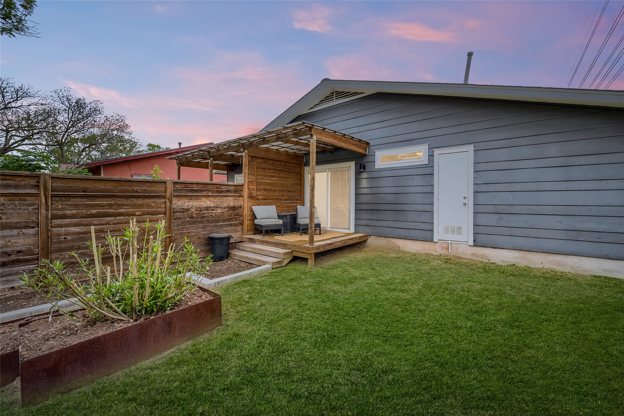 5707 Tracy Lynn Lane, Unit A Austin, TX 78721 - Photo 27 of 33 Back of house at dusk featuring a wooden deck