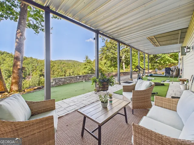 a view of a backyard with sitting area