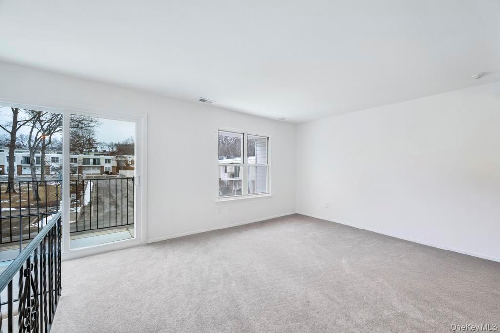 85 Rocky Point Yaphank Road, Unit 168 Rocky Point, NY 11778 - Photo 11 of 32 a view of an empty room with glass door