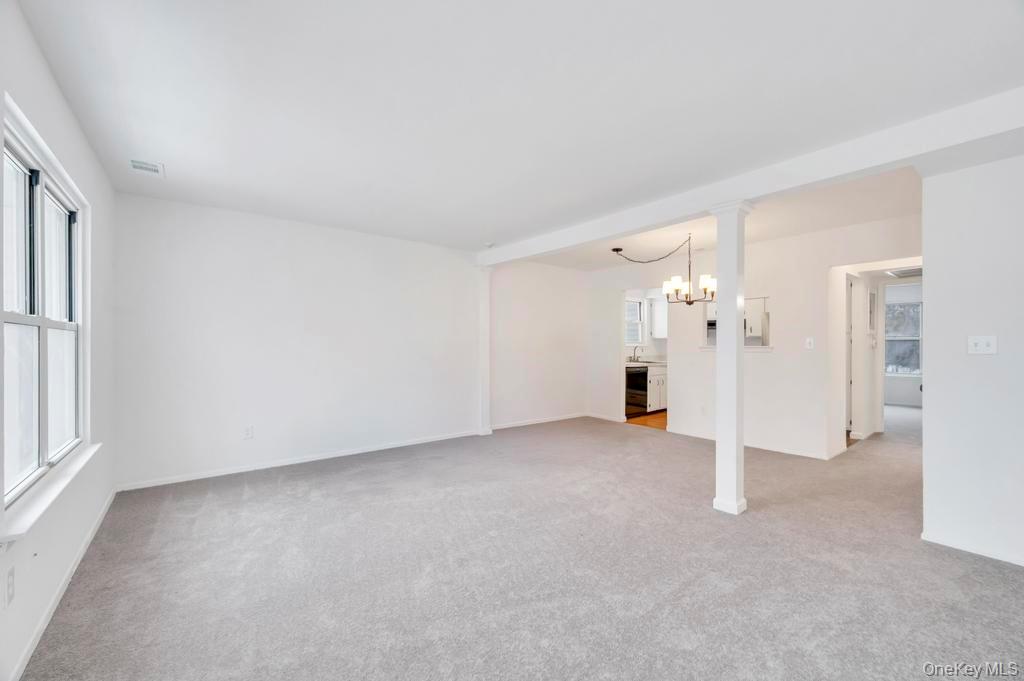 85 Rocky Point Yaphank Road, Unit 168 Rocky Point, NY 11778 - Photo 12 of 32 an empty room with a cabinet and mirrors