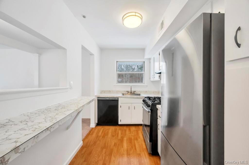85 Rocky Point Yaphank Road, Unit 168 Rocky Point, NY 11778 - Photo 18 of 32 a kitchen with a refrigerator stove and sink