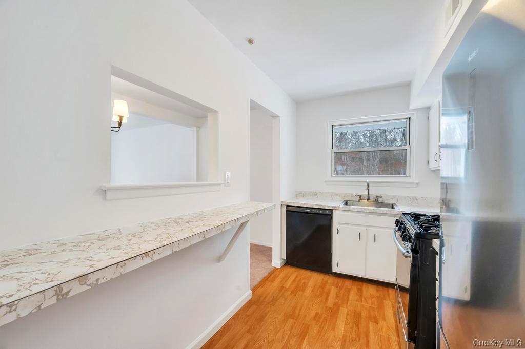 85 Rocky Point Yaphank Road, Unit 168 Rocky Point, NY 11778 - Photo 21 of 32 a spacious bathroom with a granite countertop sink a mirror and a bathtub