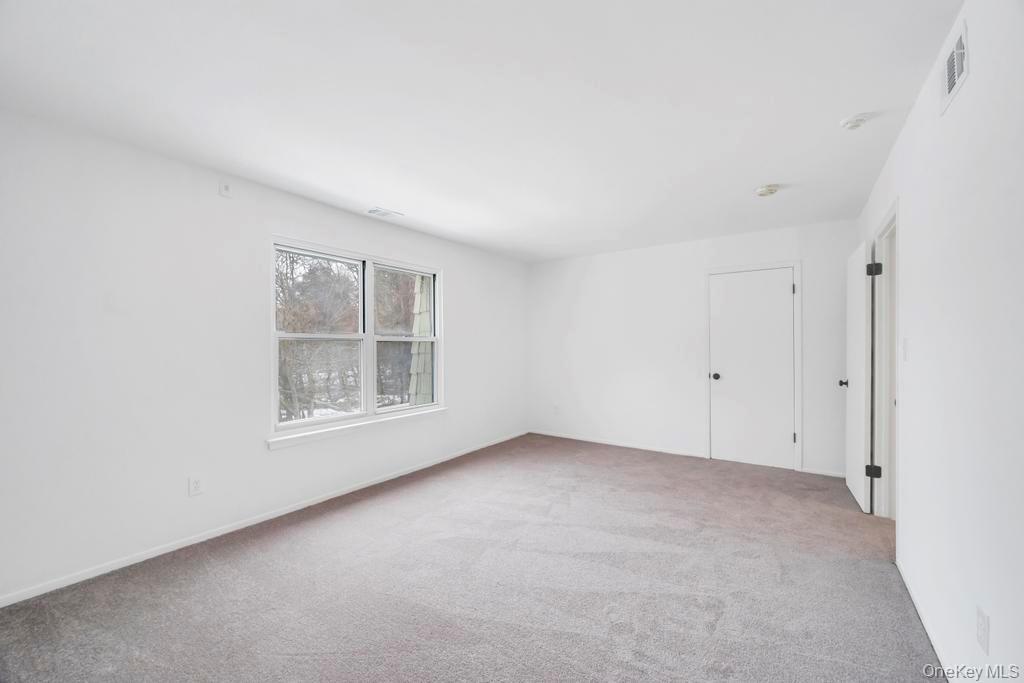 85 Rocky Point Yaphank Road, Unit 168 Rocky Point, NY 11778 - Photo 27 of 32 an empty room with a window
