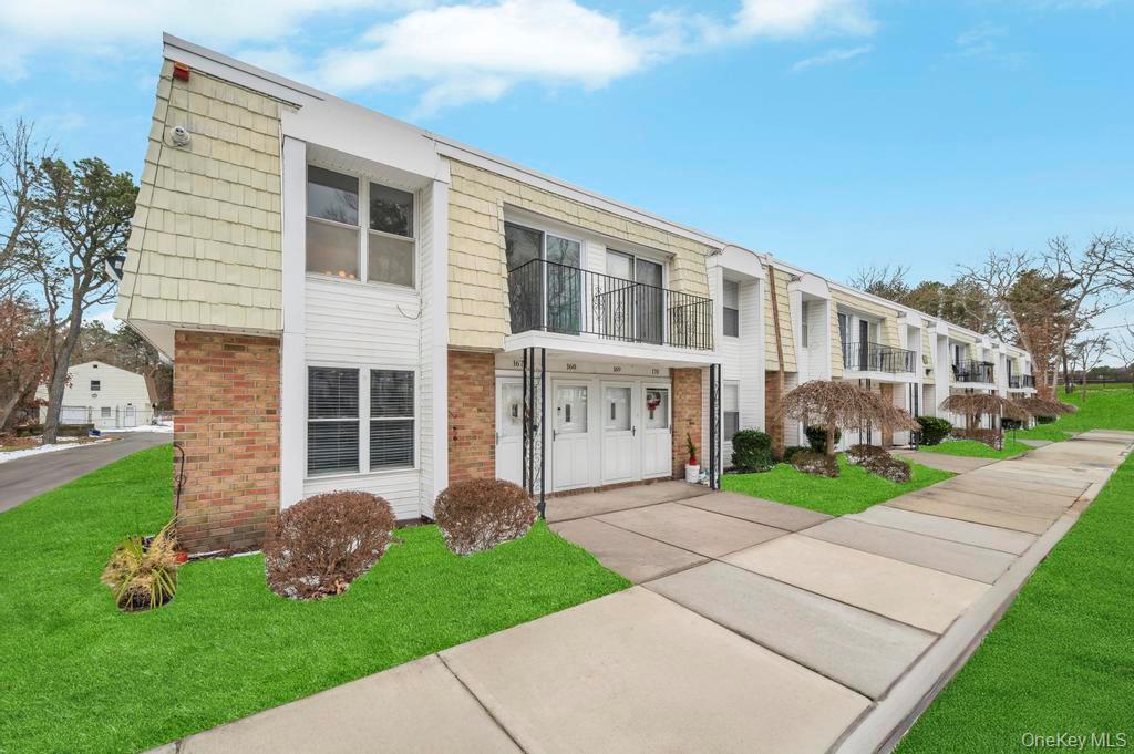 85 Rocky Point Yaphank Road, Unit 168 Rocky Point, NY 11778 - Photo 3 of 32 front view of a house with a yard
