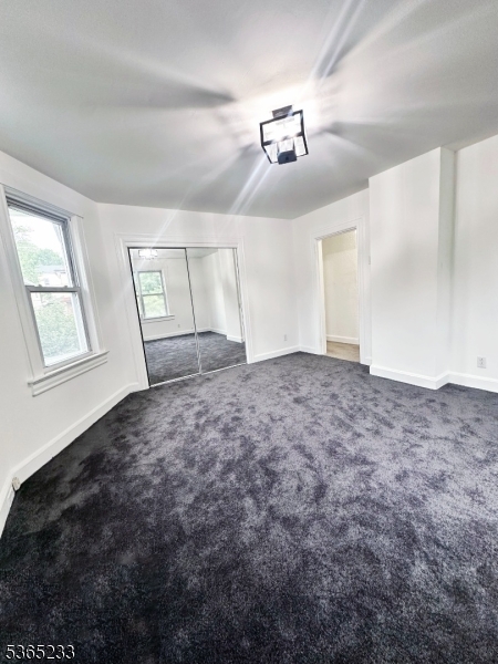 53 Hille Place, Unit 2 Ridgefield Park, NJ 07660 - Photo 2 of 9 en empty room with windows and ceiling fan