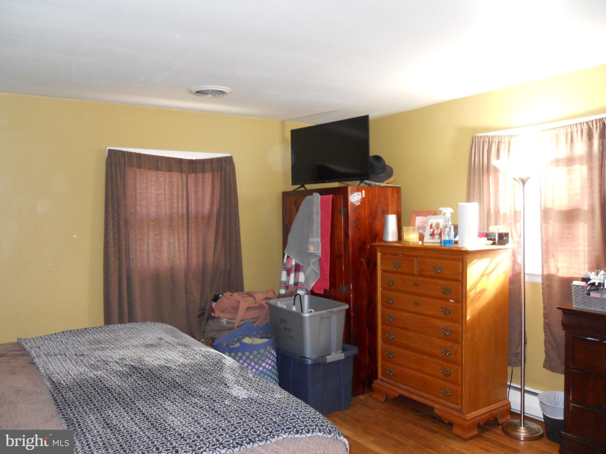164 Oberlin Avenue Reading, PA 19608 - Photo 17 of 31 a bedroom with a bed and wooden floor