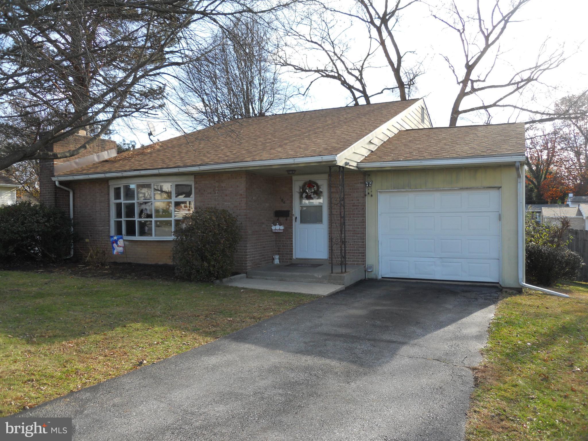 164 Oberlin Avenue Reading, PA 19608 - Photo 2 of 31 a front view of a house with a garden and trees