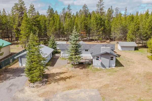 an aerial view of a house with garden space and trees