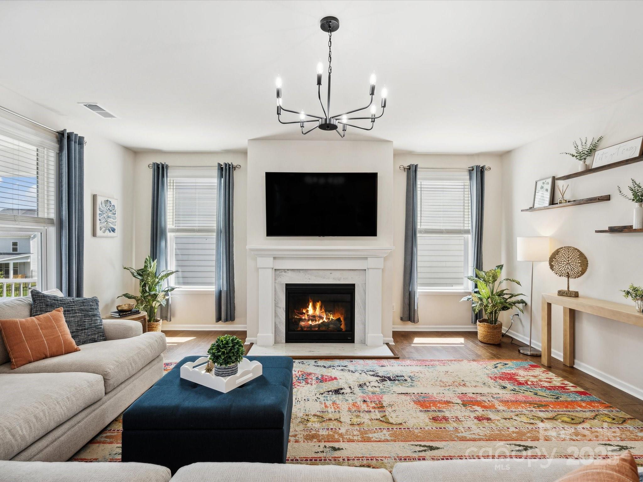 924 Stebbins Drive Fort Mill, SC 29715 - Photo 12 of 48 a living room with furniture a fireplace and a flat screen tv
