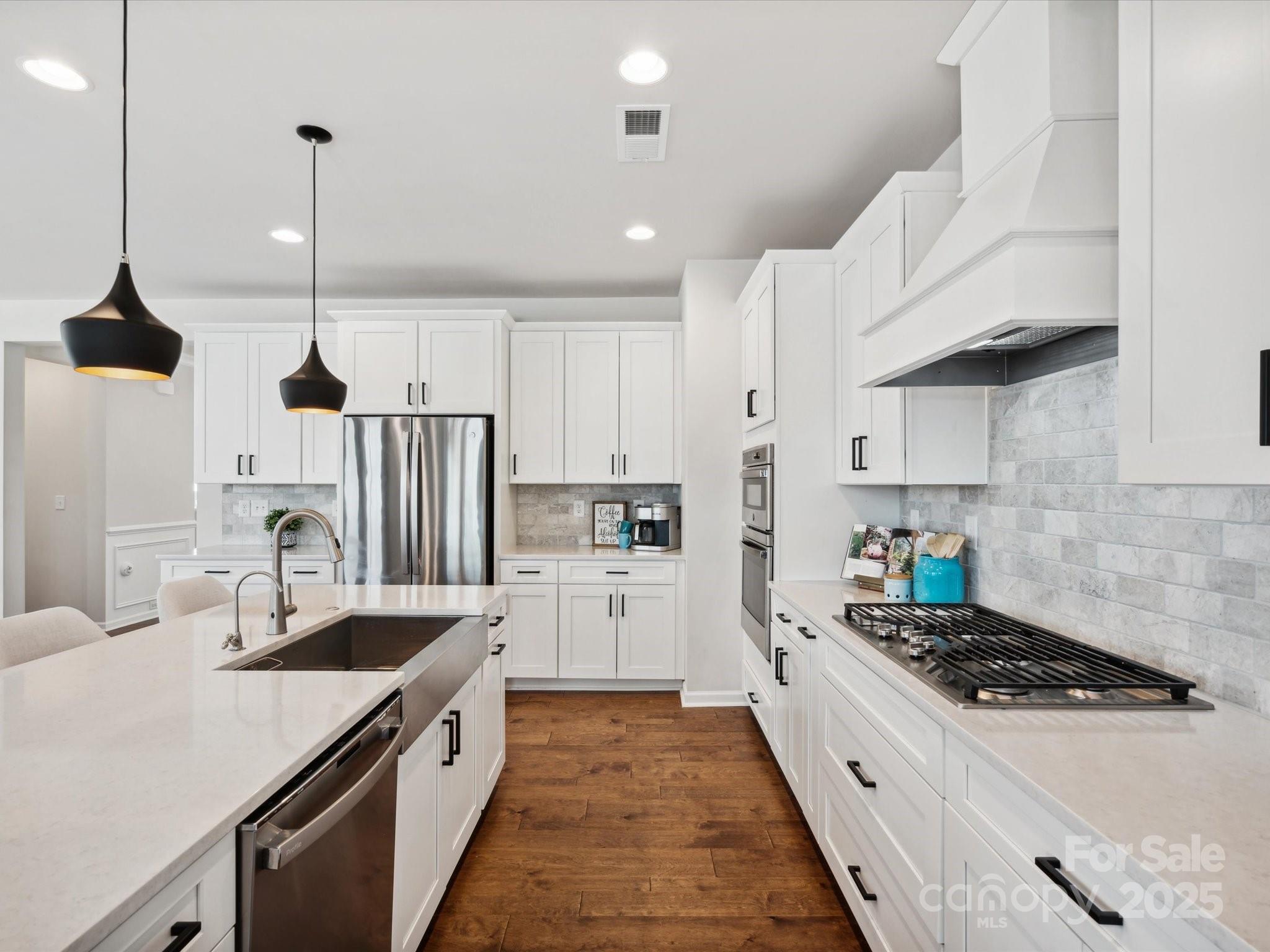 924 Stebbins Drive Fort Mill, SC 29715 - Photo 15 of 48 a kitchen with white cabinets and appliances