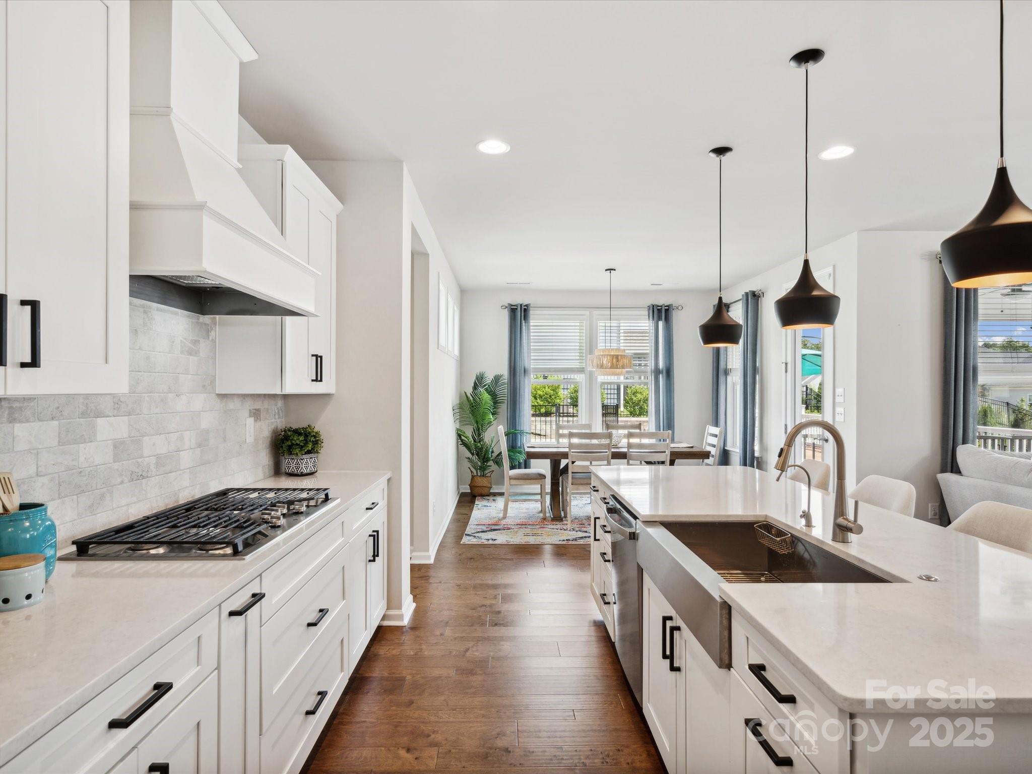 924 Stebbins Drive Fort Mill, SC 29715 - Photo 16 of 48 a kitchen with stove a sink a counter space and living room view