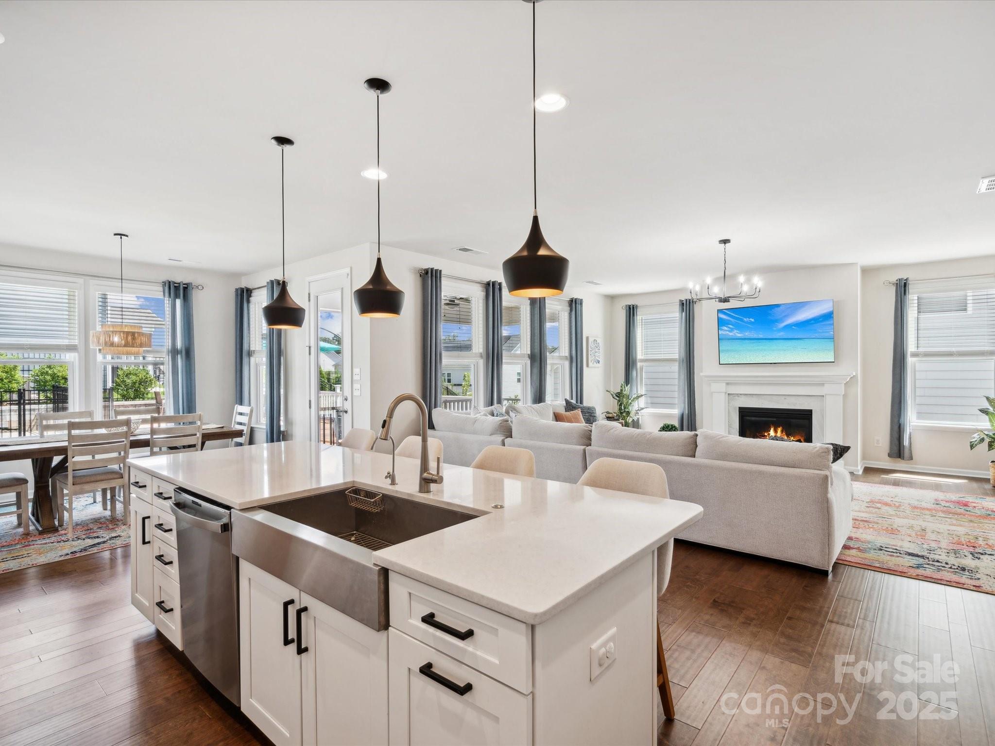 924 Stebbins Drive Fort Mill, SC 29715 - Photo 17 of 48 a kitchen with counter top space a sink stove and wooden floor