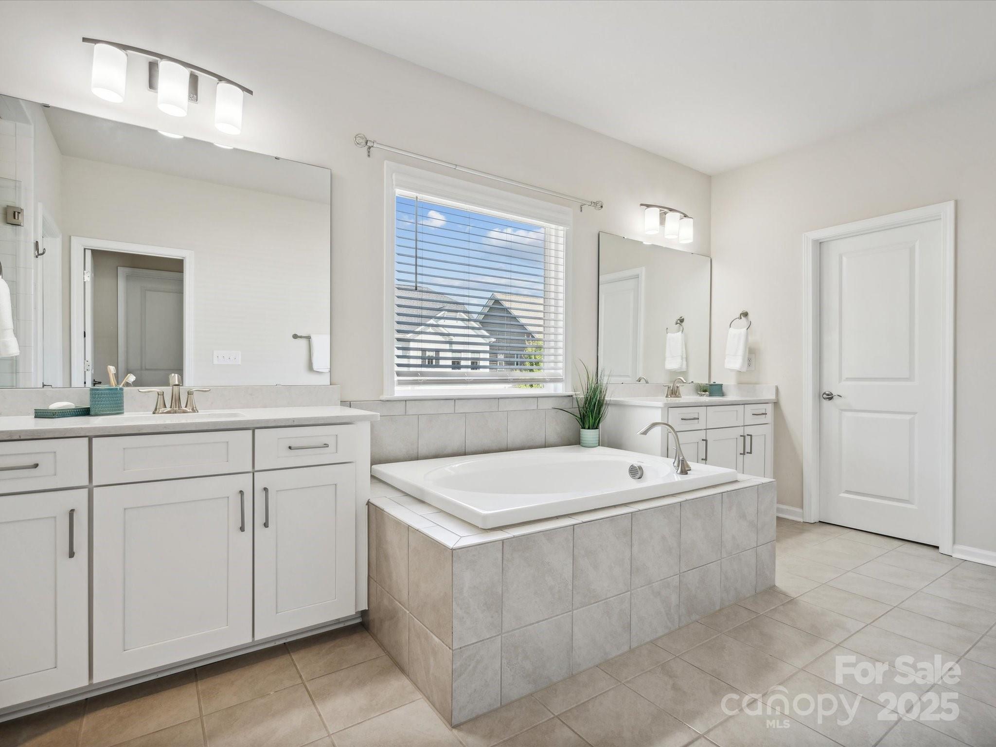 924 Stebbins Drive Fort Mill, SC 29715 - Photo 21 of 48 a spacious bathroom with a tub sink and mirror