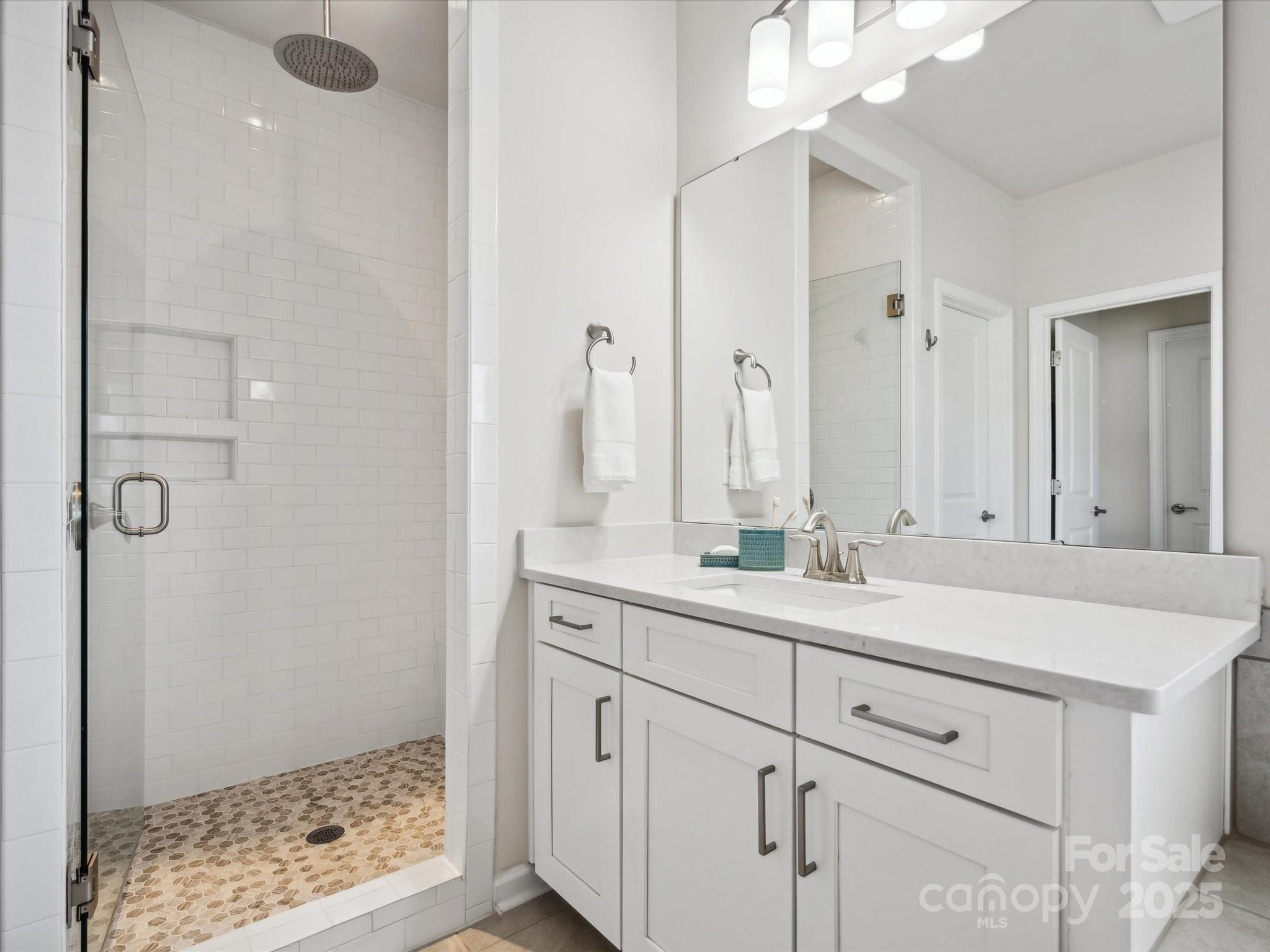 924 Stebbins Drive Fort Mill, SC 29715 - Photo 22 of 48 a bathroom with a shower sink and mirror