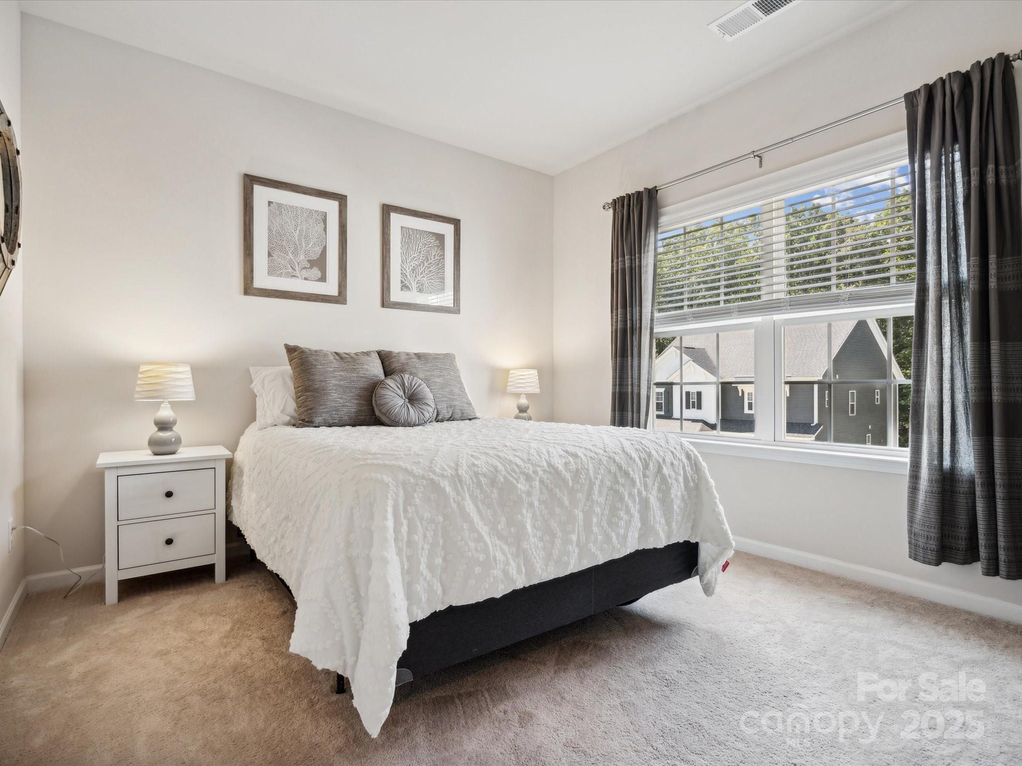 924 Stebbins Drive Fort Mill, SC 29715 - Photo 29 of 48 a bedroom with a bed and a large window