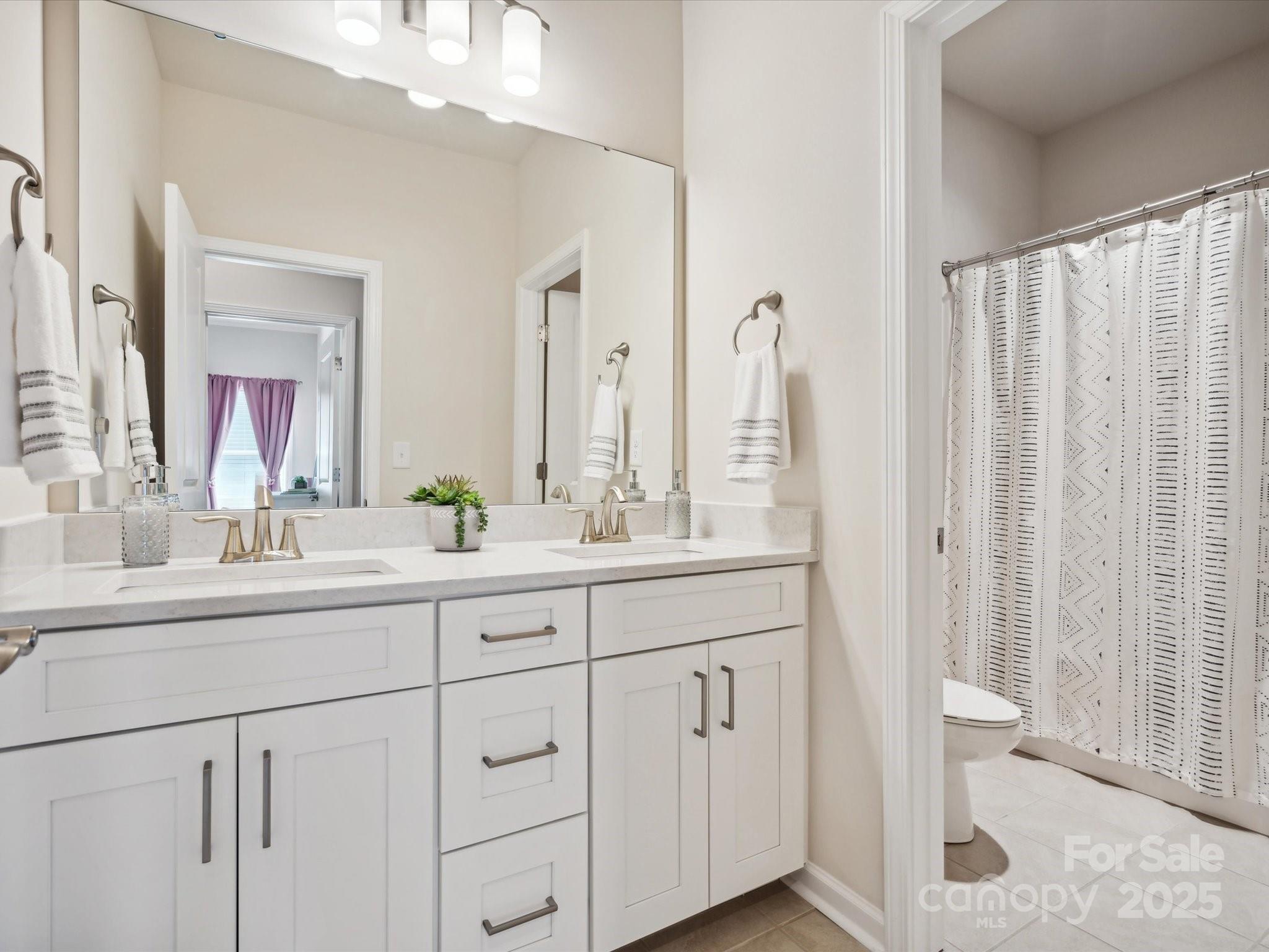 924 Stebbins Drive Fort Mill, SC 29715 - Photo 32 of 48 a bathroom with a double vanity sink and a mirror