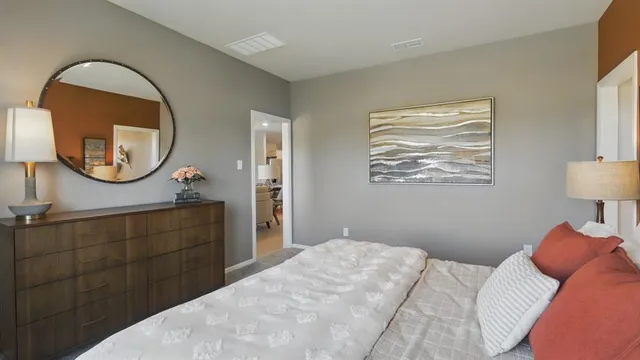 a bedroom with a bed and a table in it