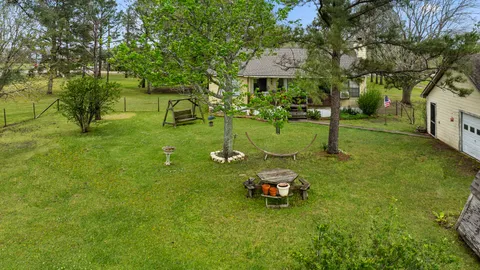 a view of a backyard with table and chairs