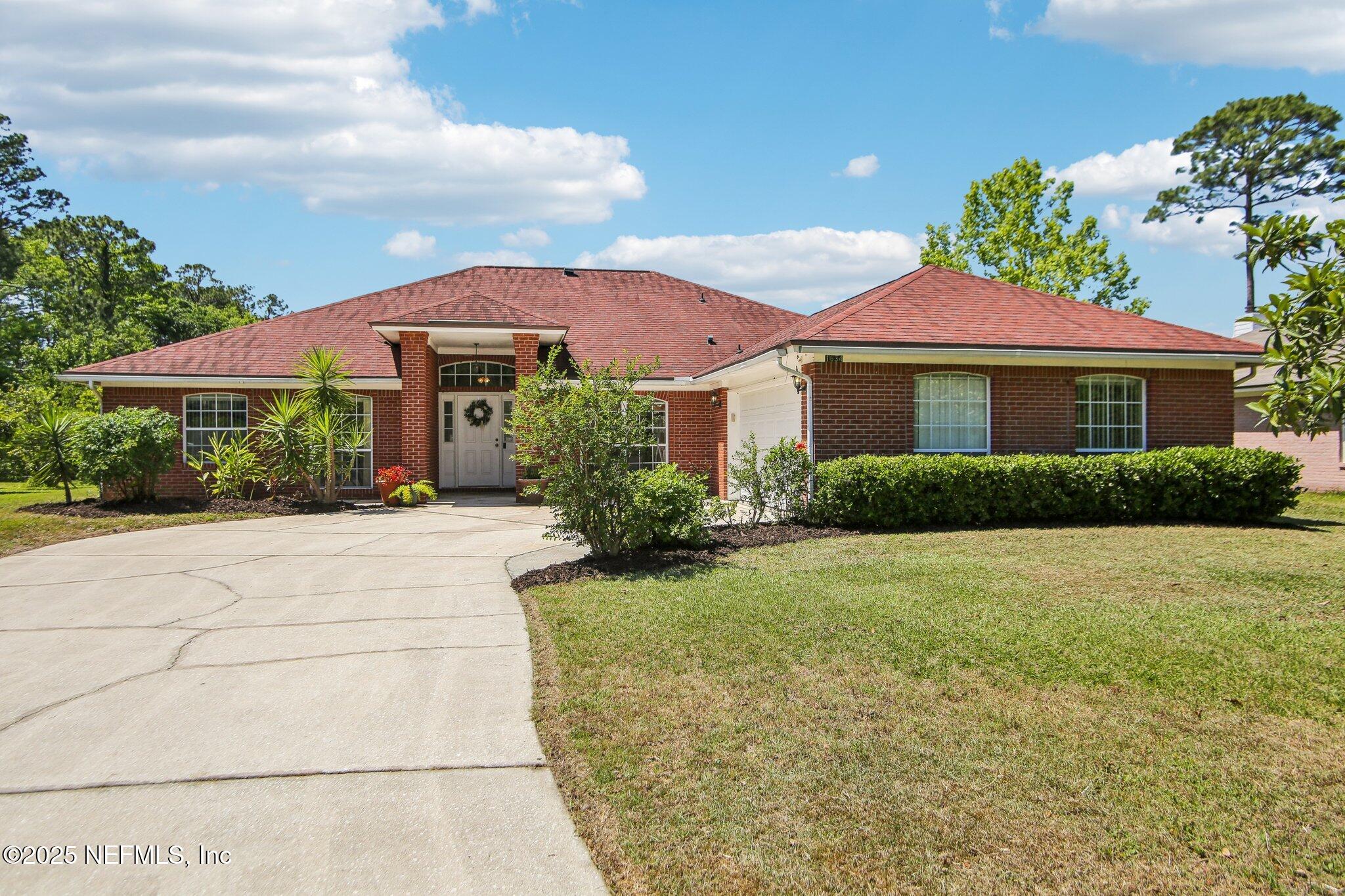 a front view of a house with garden