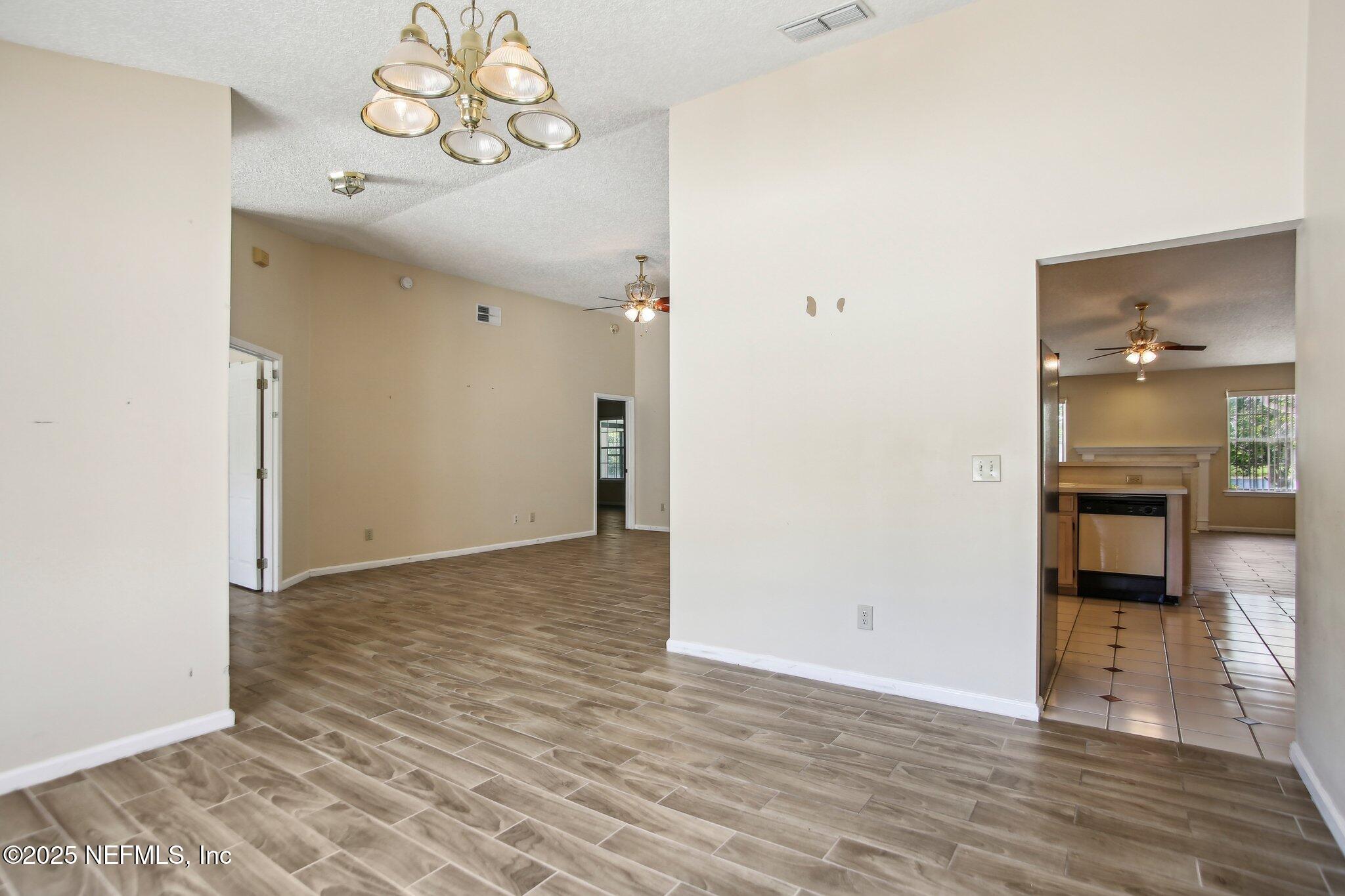 1634 Dockside Drive Fleming Island, FL 32003 - Photo 12 of 44 a view of a hallway view with wooden floor and a living room