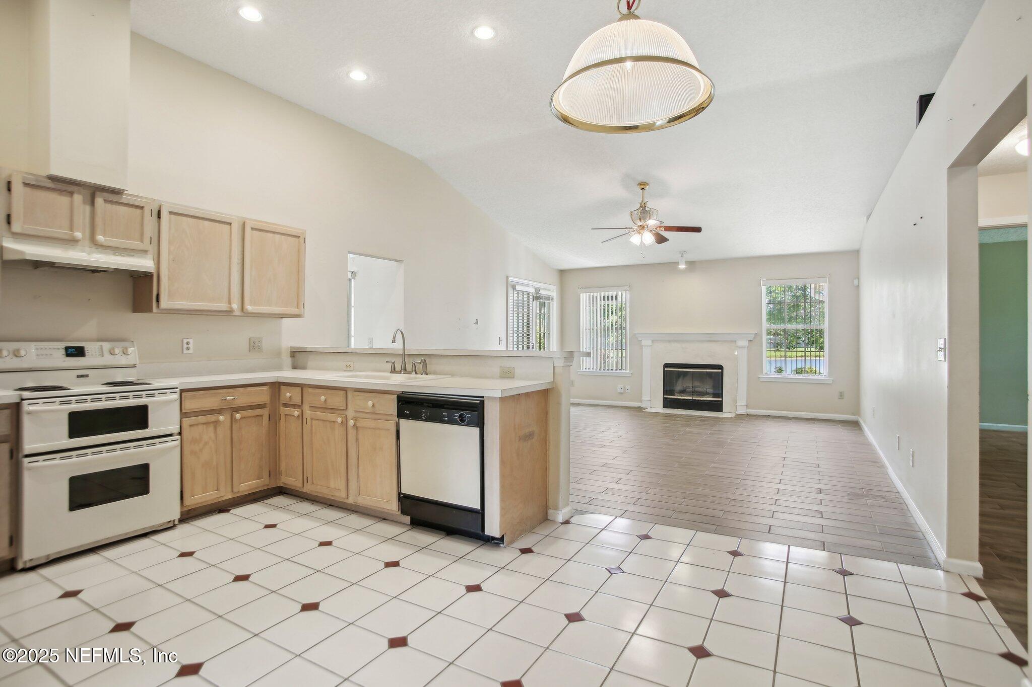 1634 Dockside Drive Fleming Island, FL 32003 - Photo 19 of 44 a kitchen with granite countertop a stove a sink and a refrigerator