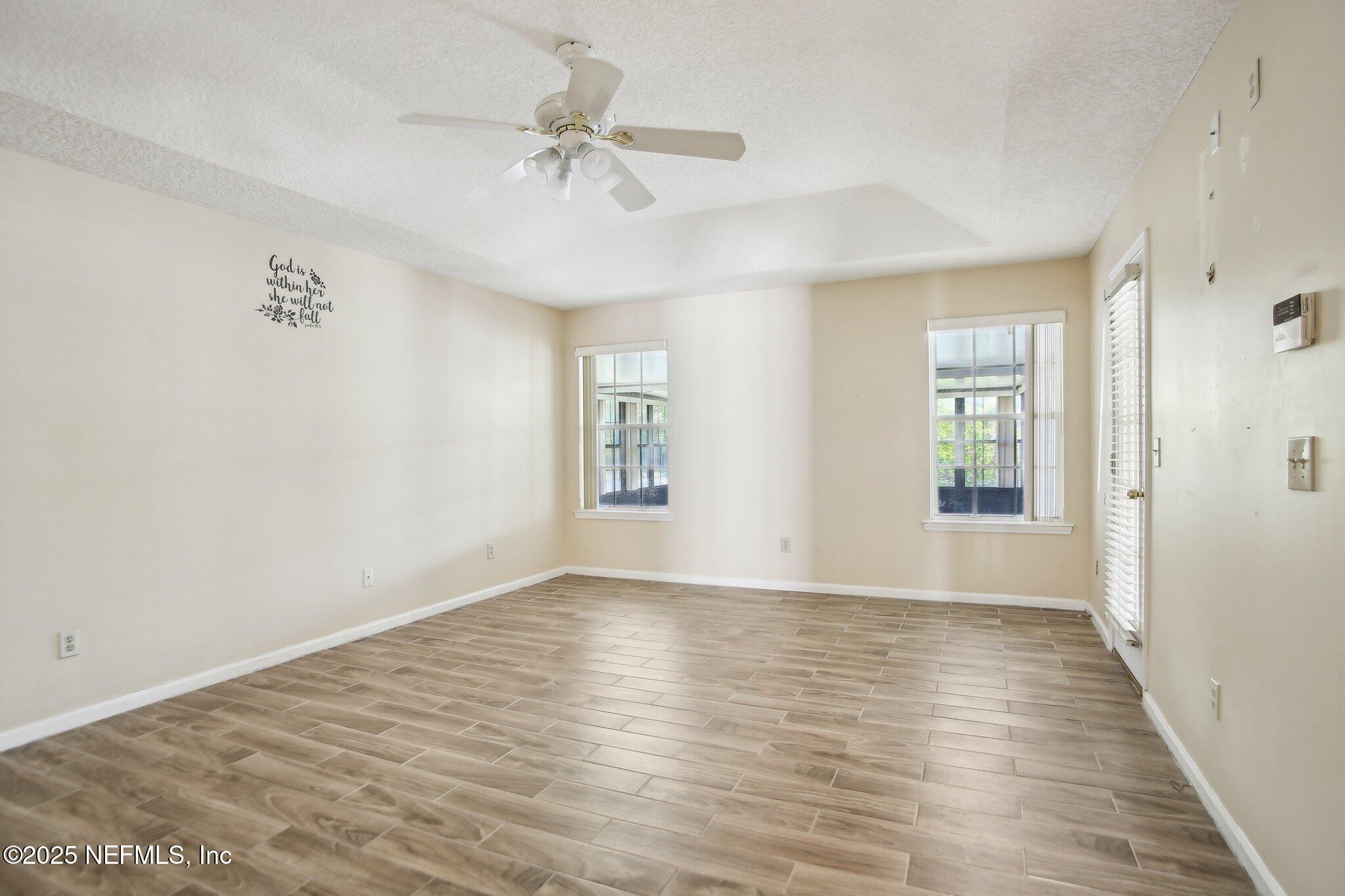 1634 Dockside Drive Fleming Island, FL 32003 - Photo 20 of 44 a view of an empty room with wooden floor and a window
