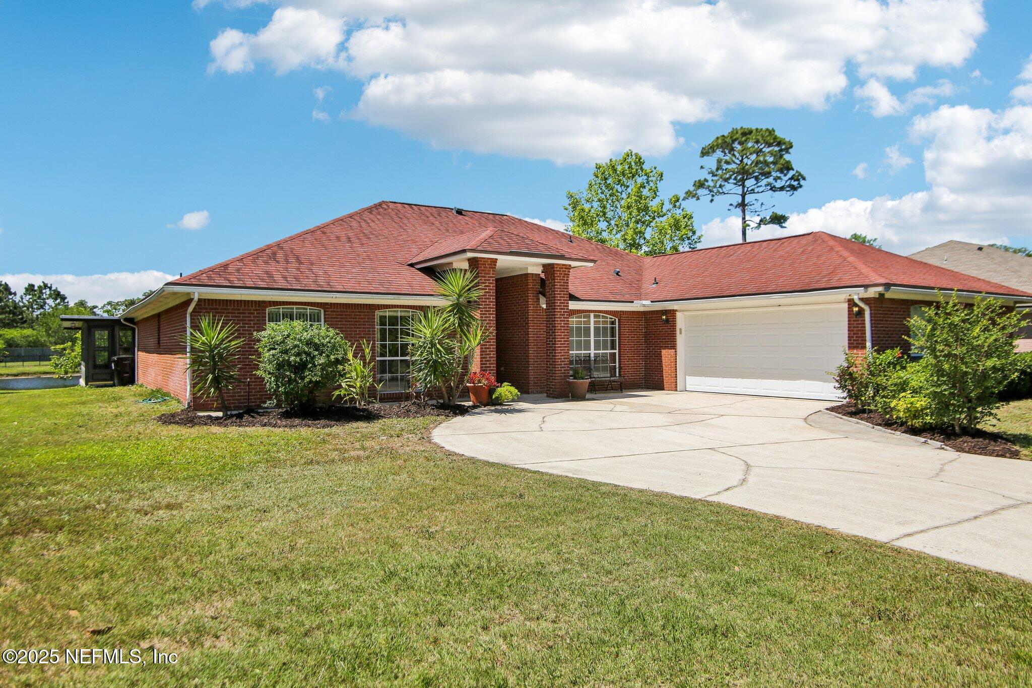 1634 Dockside Drive Fleming Island, FL 32003 - Photo 2 of 44 a front view of a house with garden