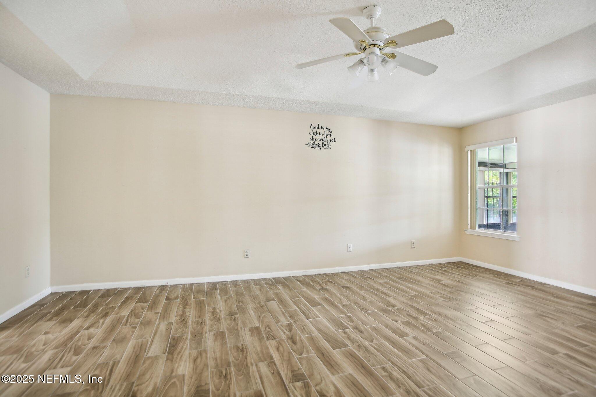 1634 Dockside Drive Fleming Island, FL 32003 - Photo 21 of 44 wooden floor in an empty room with a window