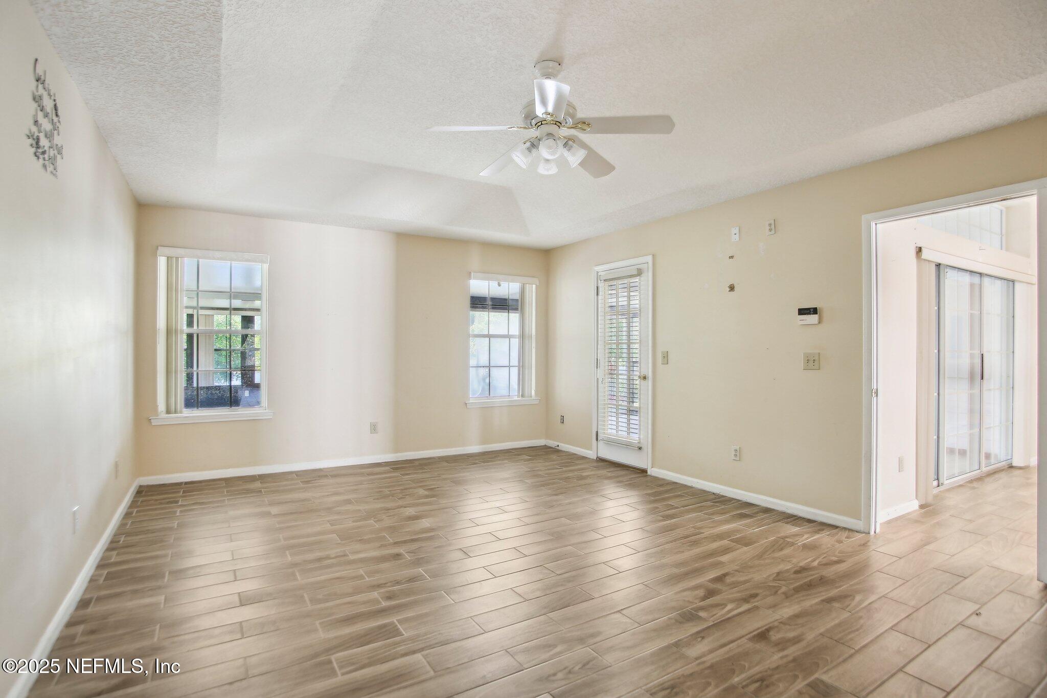 1634 Dockside Drive Fleming Island, FL 32003 - Photo 22 of 44 a view of an empty room with wooden floor and a window