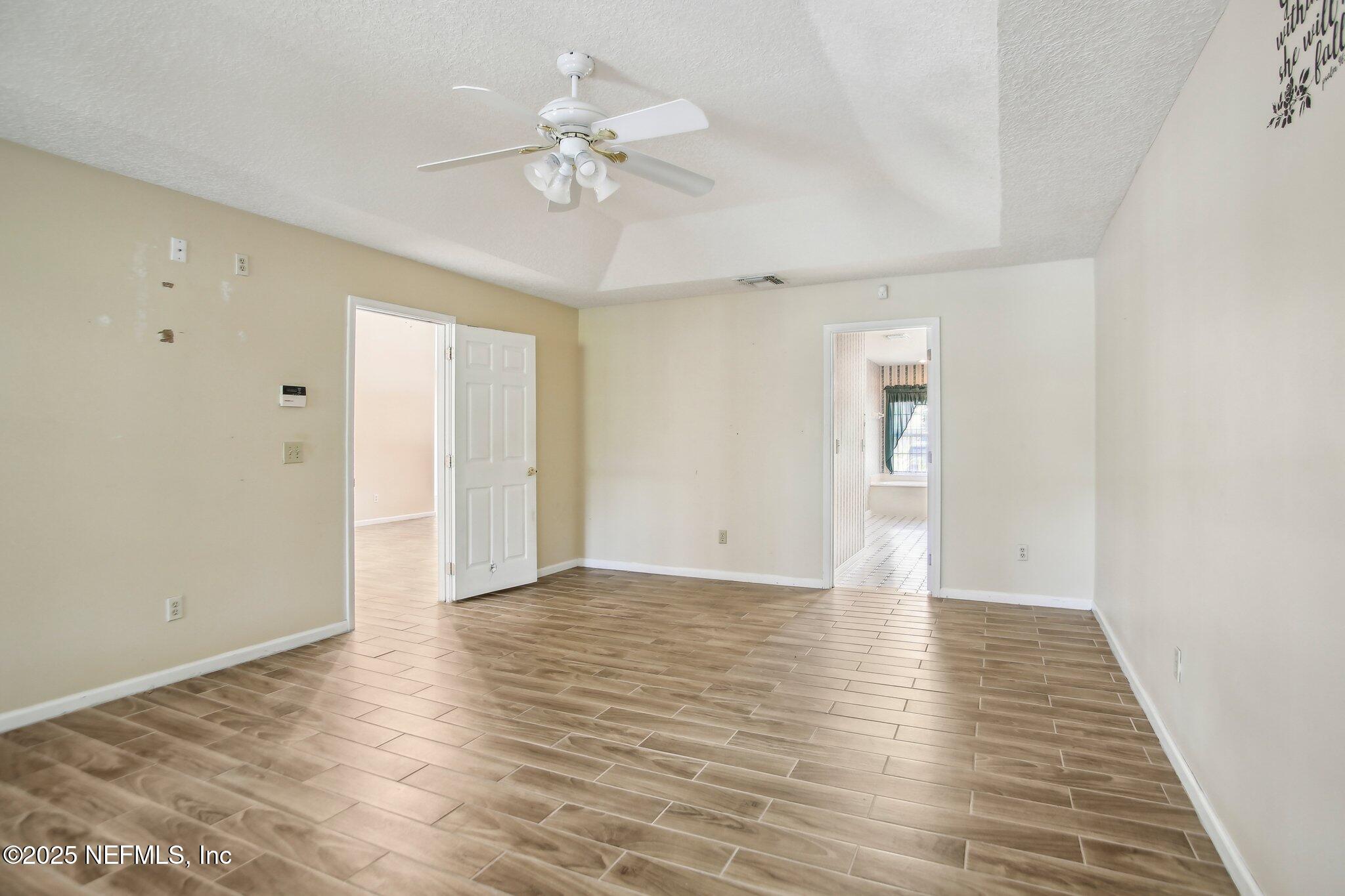 1634 Dockside Drive Fleming Island, FL 32003 - Photo 23 of 44 a view of an empty room with wooden floor