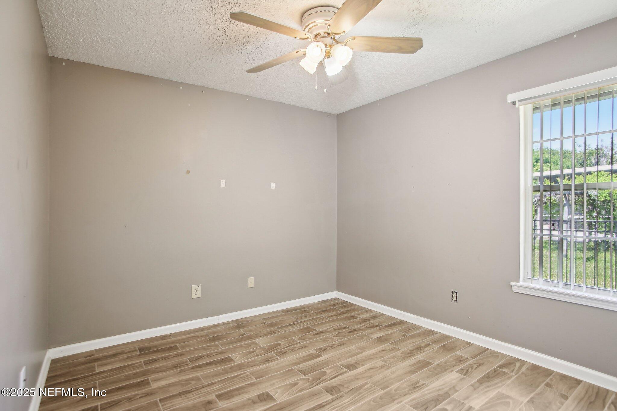 1634 Dockside Drive Fleming Island, FL 32003 - Photo 25 of 44 wooden floor in an empty room with a window