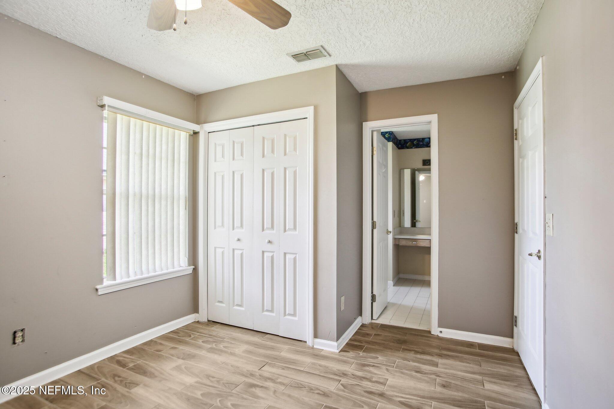 1634 Dockside Drive Fleming Island, FL 32003 - Photo 26 of 44 an empty room with window and closet area