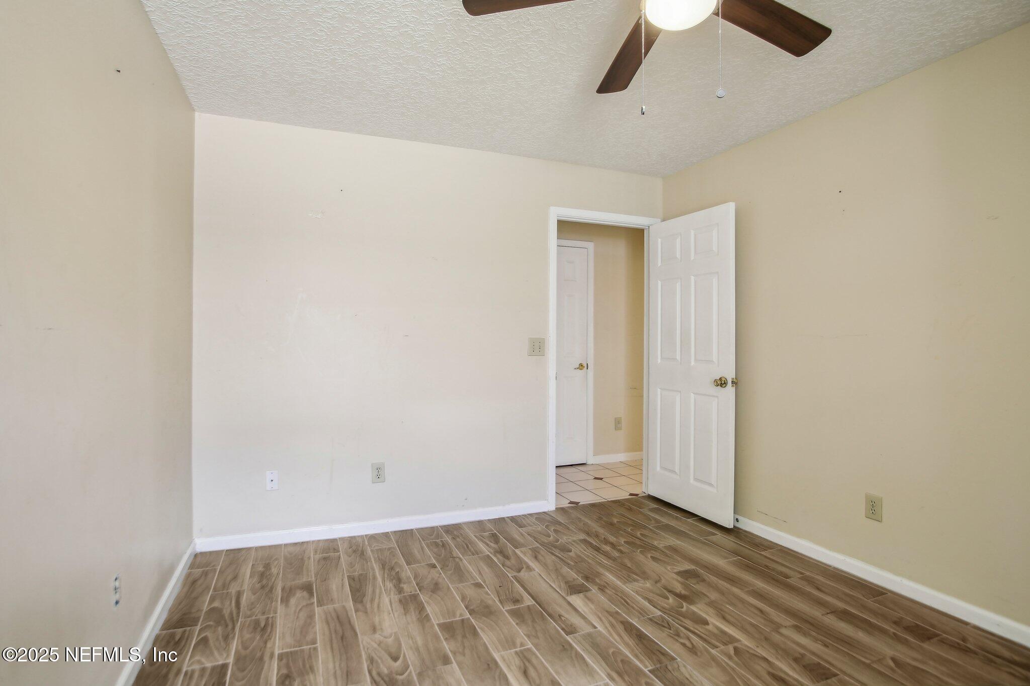 1634 Dockside Drive Fleming Island, FL 32003 - Photo 27 of 44 an empty room with wooden floor and ceiling fan