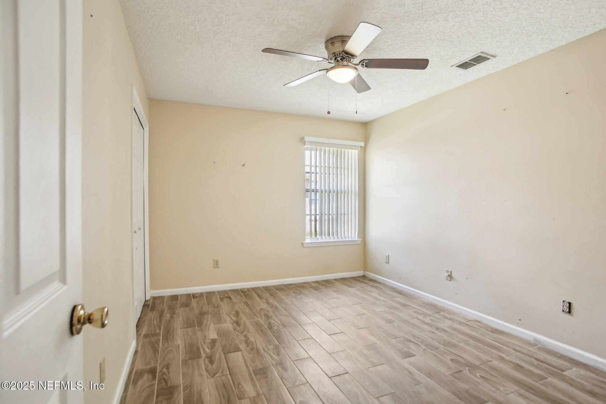 1634 Dockside Drive Fleming Island, FL 32003 - Photo 28 of 44 wooden floor in an empty room with a window