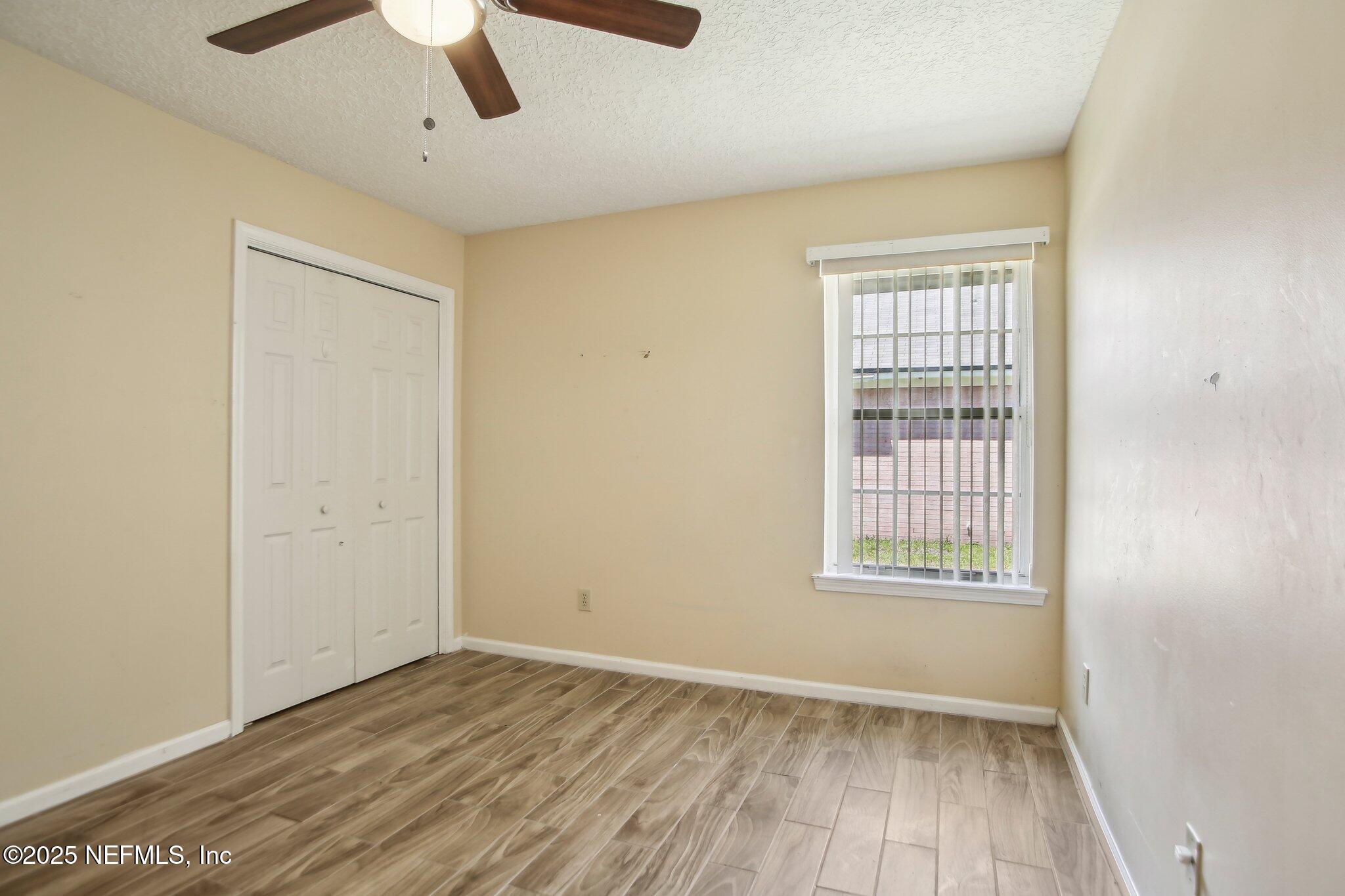 1634 Dockside Drive Fleming Island, FL 32003 - Photo 29 of 44 wooden floor in an empty room with a window