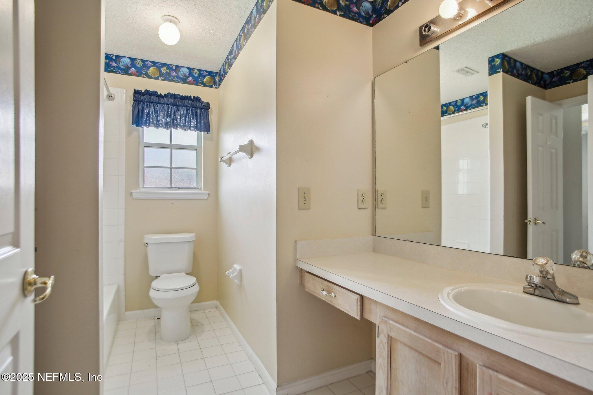 1634 Dockside Drive Fleming Island, FL 32003 - Photo 30 of 44 a bathroom with a sink a toilet and shower