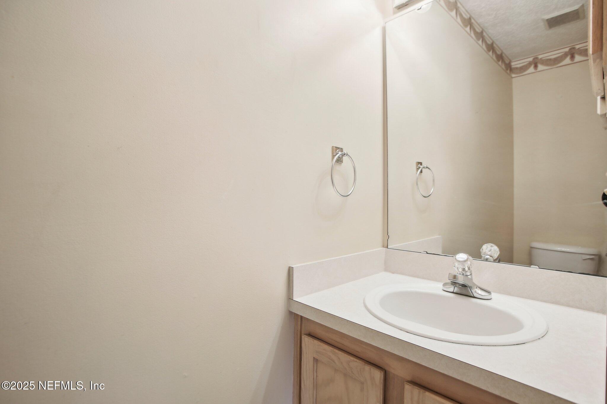 1634 Dockside Drive Fleming Island, FL 32003 - Photo 36 of 44 a bathroom with a sink and a mirror