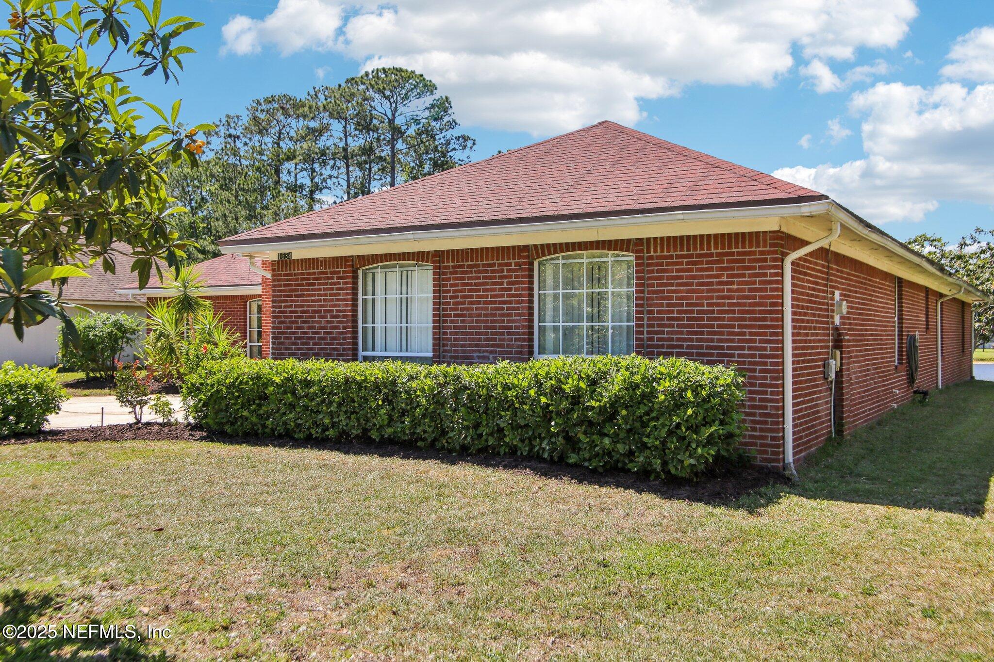 1634 Dockside Drive Fleming Island, FL 32003 - Photo 4 of 44 a front view of a house with a yard