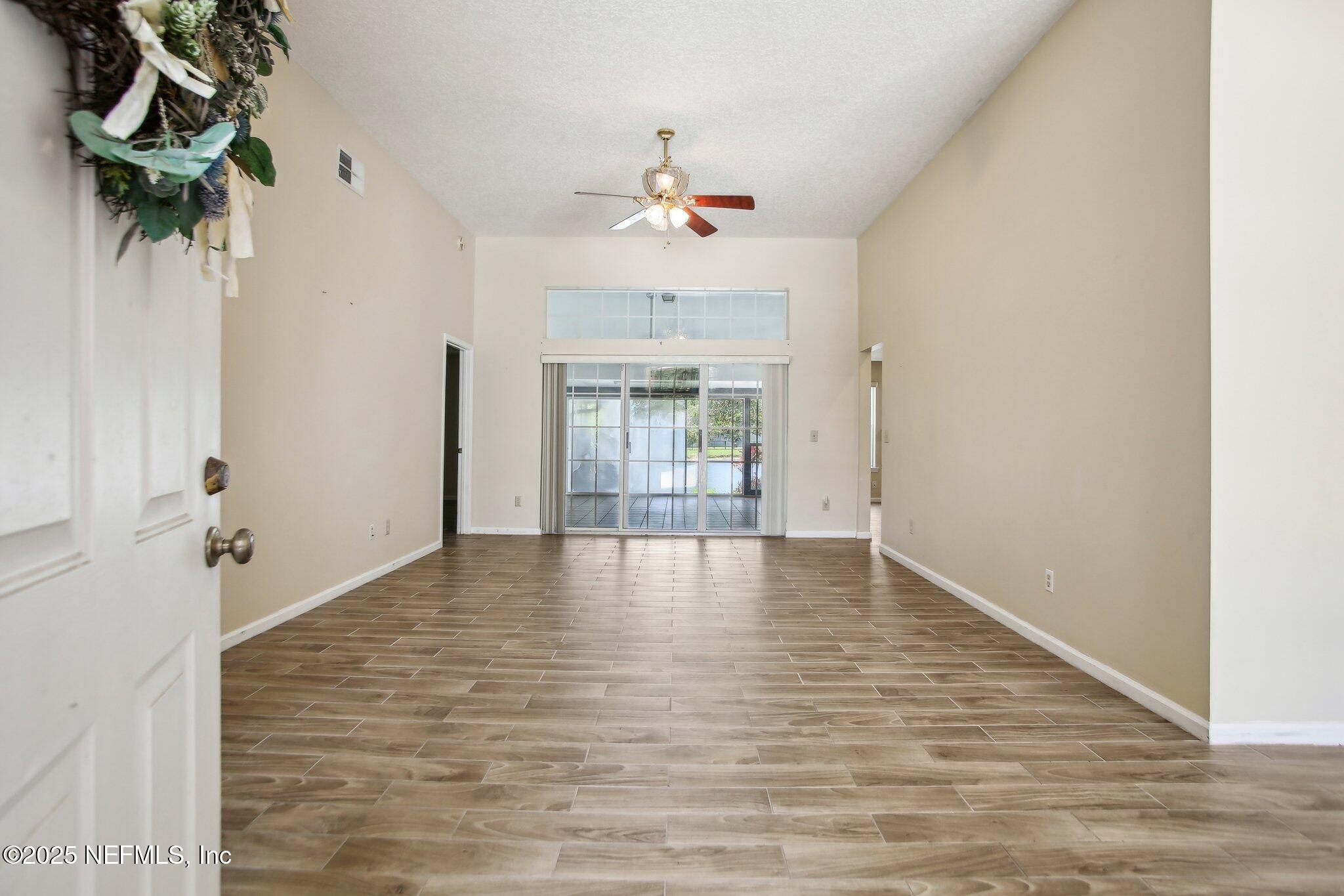 1634 Dockside Drive Fleming Island, FL 32003 - Photo 5 of 44 wooden floor in an empty room with a window