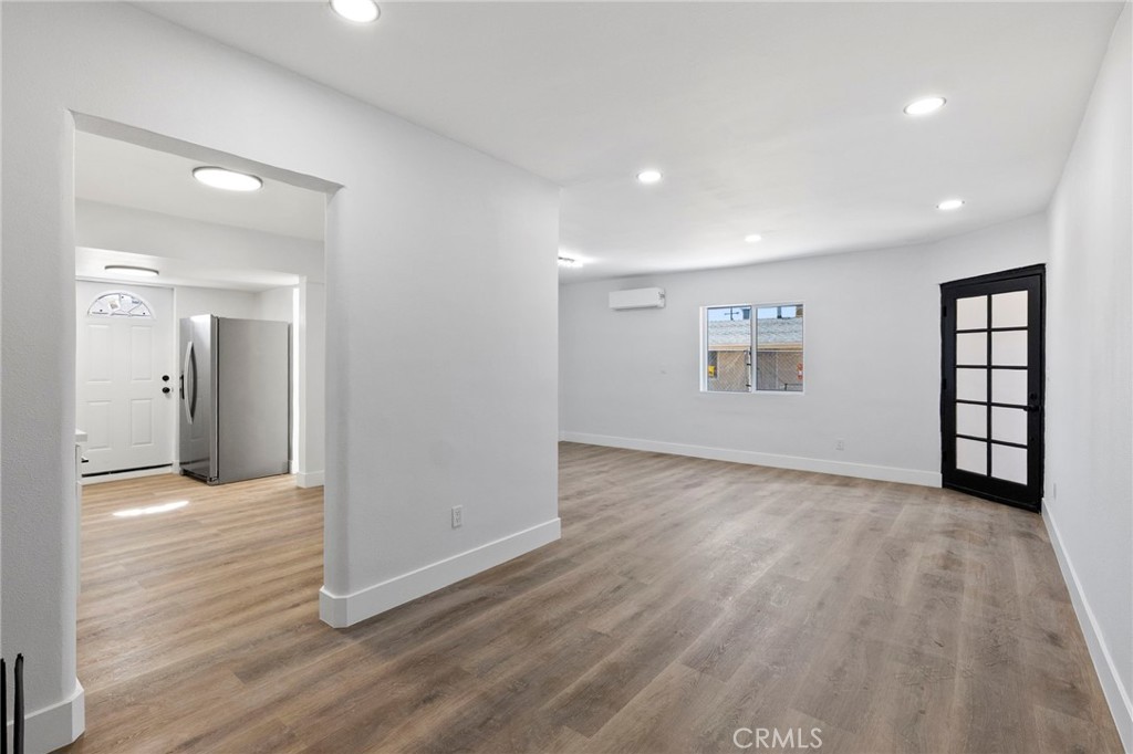25441 Main Street Barstow, CA 92311 - Photo 14 of 66 wooden floor in an empty room with a window