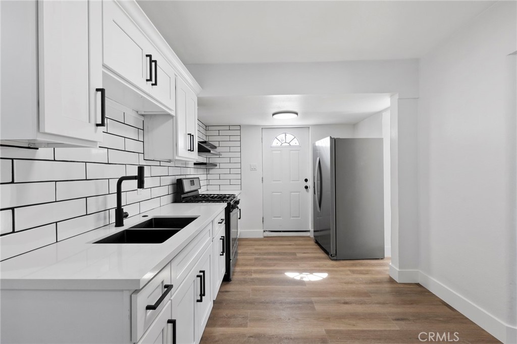 25441 Main Street Barstow, CA 92311 - Photo 17 of 66 a kitchen with a sink cabinets and stainless steel appliances