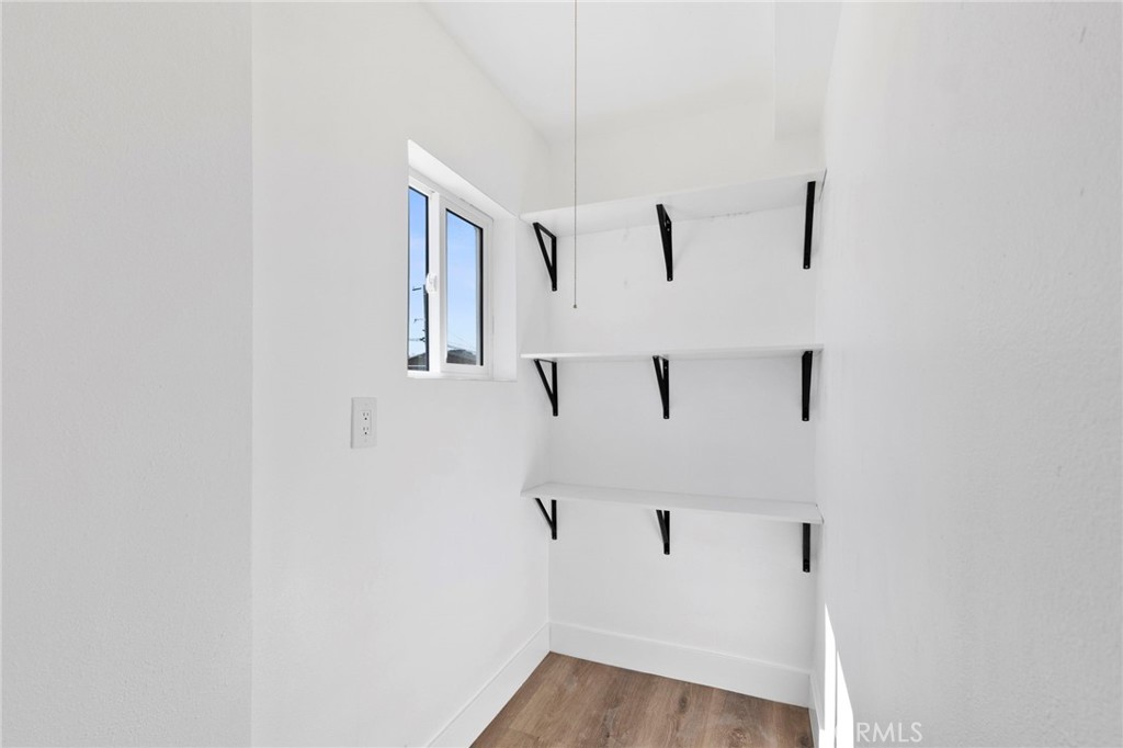 25441 Main Street Barstow, CA 92311 - Photo 22 of 66 a view of a hallway with wooden floor