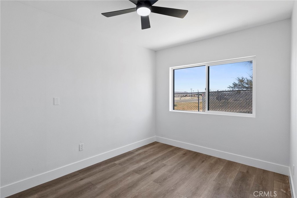 25441 Main Street Barstow, CA 92311 - Photo 24 of 66 an empty room with a window and ceiling fan