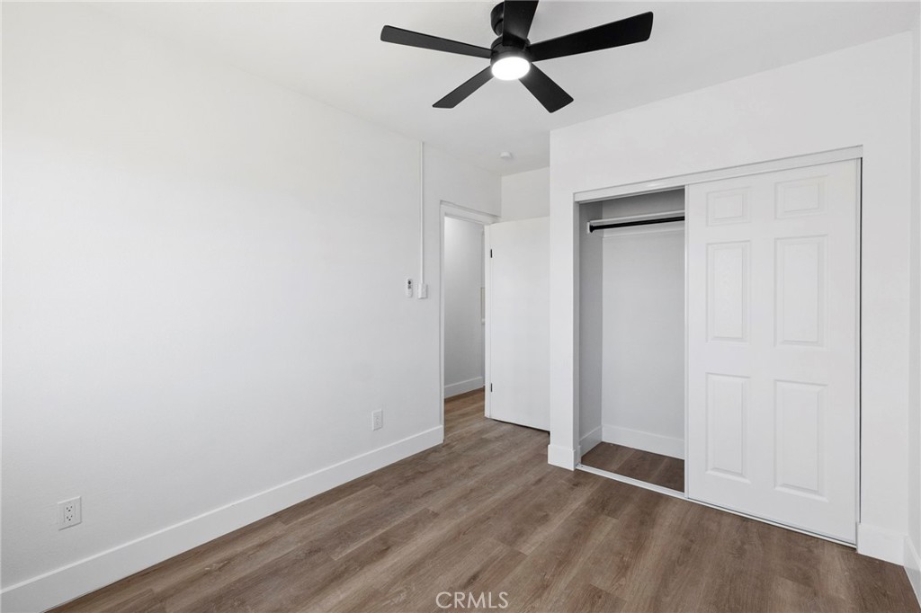 25441 Main Street Barstow, CA 92311 - Photo 25 of 66 an empty room with wooden floor and windows